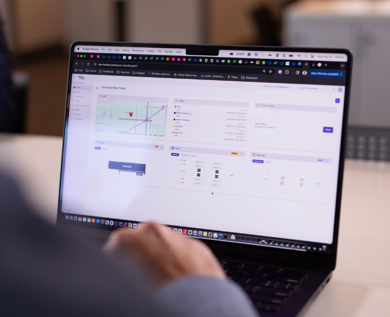 A fleet manager using a laptop to view Road Ready fleet management dashboard