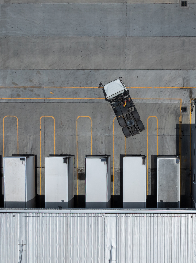 Trailers at loading dock for freight operations Aerial view of semi-trailers parked at a loading dock facility